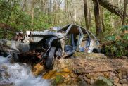 Remains of a car beside a mountain stream, which apparently fell from a dirt road up the mountain, in Unicoi County, Tennessee.