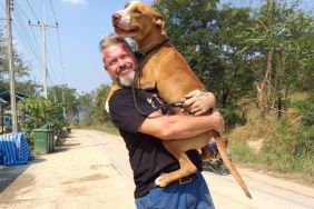 Michael J. Baines, co-founder and president of The Man That Rescues Dogs who wrote a new book to help raise funds for stray and disabled canines, with a dog.