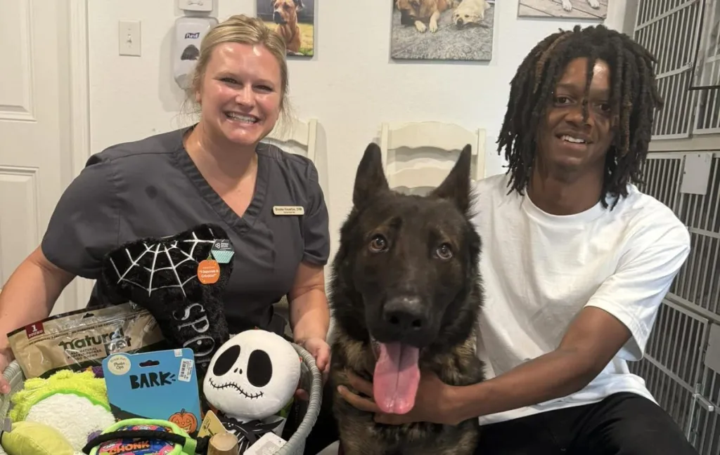 Homeless teen Samuel and his dog, Mordex, pose with the vet tech.