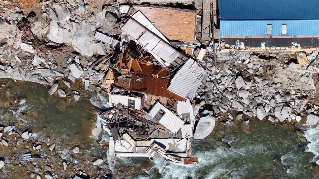 An aerial view of destroyed and damaged buildings in the aftermath of Hurricane Helene flooding, similar to the one a dog rescued a boy from, on October 8, 2024 in Bat Cave, North Carolina.