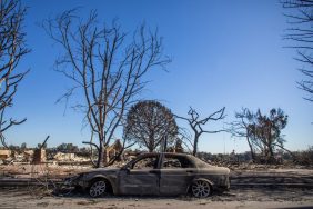 A burned car from the Palisades Fire is seen in the Pacific Palisades neighborhood on January 15, 2025 in Los Angeles.