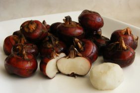 Fresh water chestnuts on a board.