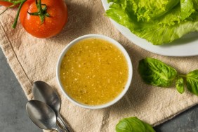 A closeup photograph of homemade Italian dressing, one of many salad dressings that dogs cannot eat safely.