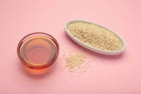 Sesame seeds and sesame oil in bowl.