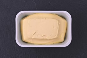 Just opened margarine box on a plate of slate.