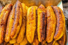 A closeup photo of sweet plantains in a tray. Dogs can eat plantains provided they are cooked.
