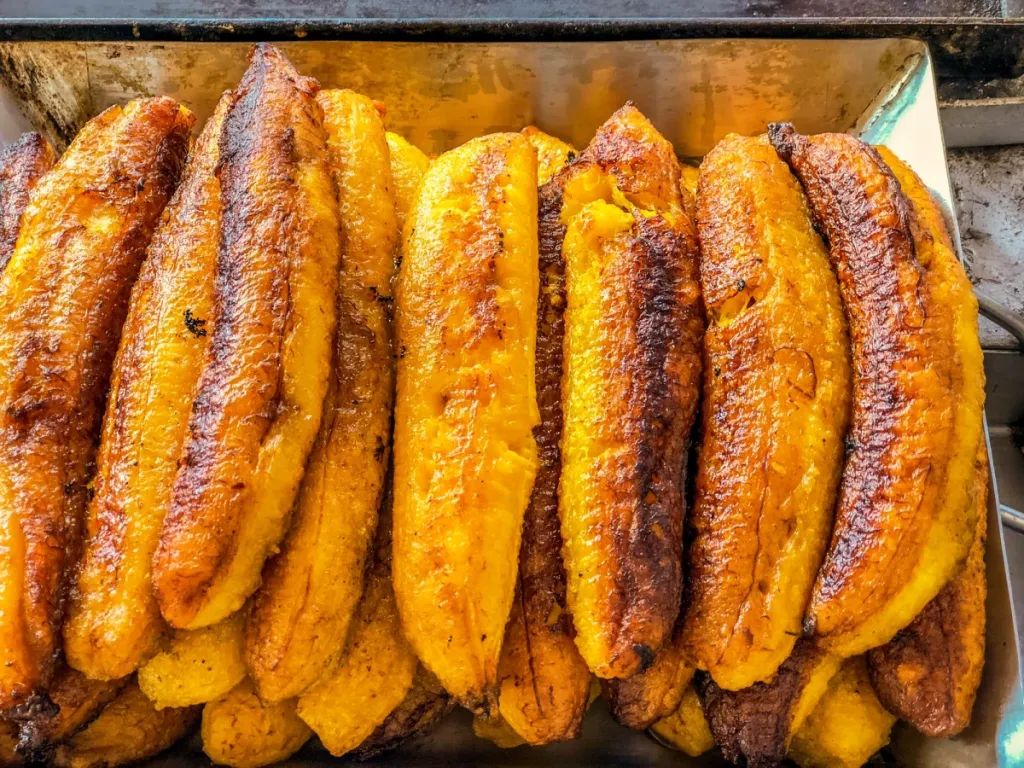 A closeup photo of sweet plantains in a tray. Dogs can eat plantains provided they are cooked.