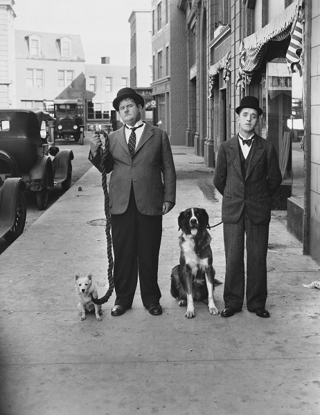 Laurel And Hardy Take A Break From Filming On Set To Walk Their Pups